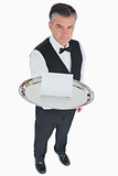 Man serving silver tray with blank card
