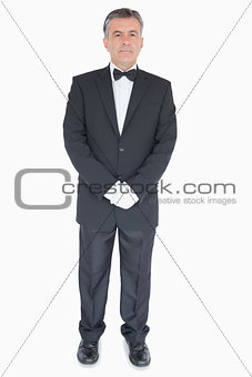 Waiter standing with crossed arms