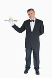 Smiling waiter holding tray with glasses of whiskey