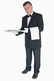 Waiter standing against the white background holding silver tray