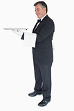 Waiter holding silver tray and towel