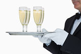 Waiter carrying tray full glasses of champagne