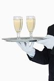 Waiter holding tray of champagne flutes