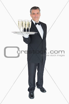 Waiter offering tray with glasses of champagne