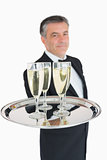 Waiter holding out tray with champagne