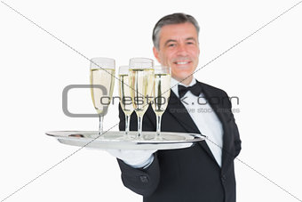 Waiter serving tray full of glasses with champagne