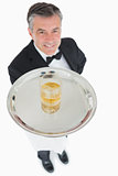 Waiter offering whiskey on tray
