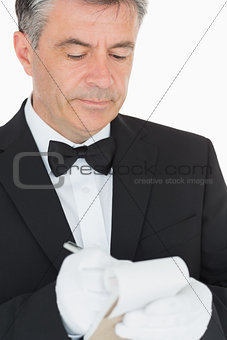 Waiter writing into his notebook