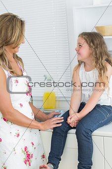 Mother and daughter sitting on the sideboard