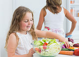 Daughter preparing salad