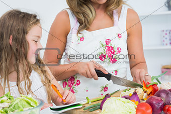 Mother cutting vegetables