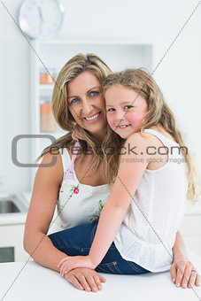 Mother and daughter posing before camera