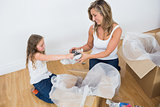 Mother and daughter unpacking things