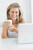 Smiling woman holding a mug