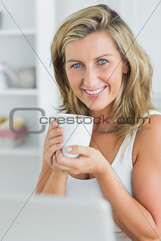 Happy woman holding mug