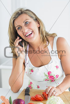 Woman calling during preparing vegetables