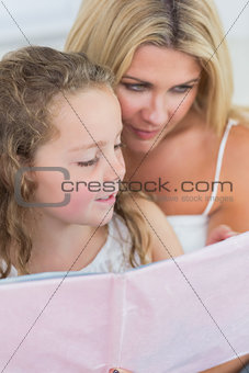 Mother and daughter reading together