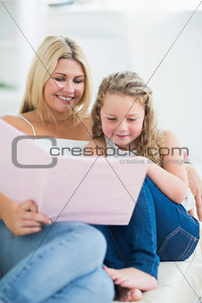 Mother sitting on the sofa with her daughter