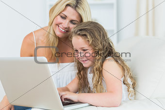 Daughter and mother working with notebook