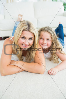 Mother and daughter resting on the carpet