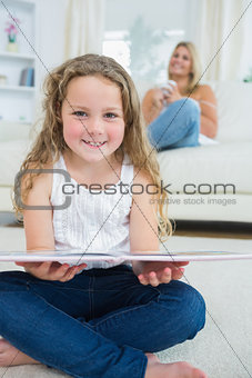 Laughing daughter with a book