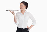 Waitress holding a tray and looking at it
