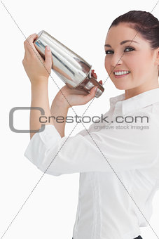 Woman using cocktail shaker