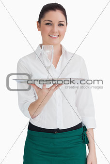 Waitress holding tray with glass