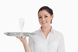 Waitress holding silver tray with glass