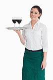 Woman holding tray with glasses of wine