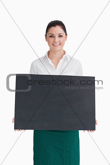 Smiling woman holding a black panel