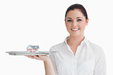 Waitress holding tray with miniature house
