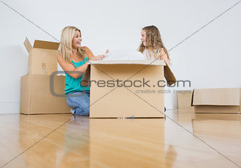 Mother and daughter unpacking