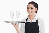 Smiling waitress holding two glasses