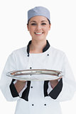 Happy chef holding a silver tray