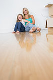 Mother and daughter sitting on the floor together