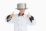 Cook having fun with a pot on her head