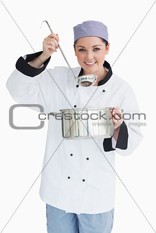 Glad cook serving with a ladle and a pot