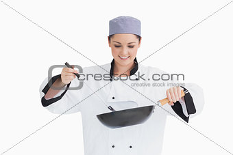 Cook cooking with wok and spoon
