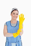 Maid putting on yellow gloves