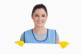 Smiling cleaning woman showing a white panel