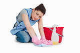 Exhausted cleaning woman wiping up the floor