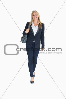 Smiling business woman walking