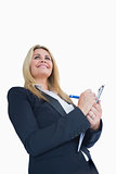 Smiling business woman writing in the clipboard