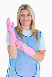 Cleaner woman putting pink gloves on