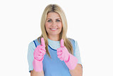 Smiling cleaner putting thumbs up with pink gloves