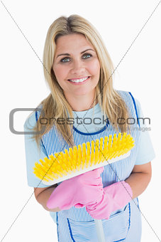 Cleaner woman holding a yellow broom