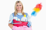 Cleaner woman holding a pink bucket with cleaning supplies