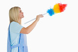 Cleaning woman using a feather duster