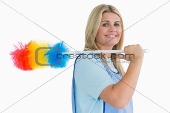 Smiling cleaning woman holding feather duster